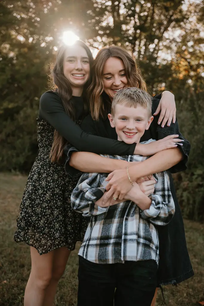 Mom smiling and hugging kids during family photos